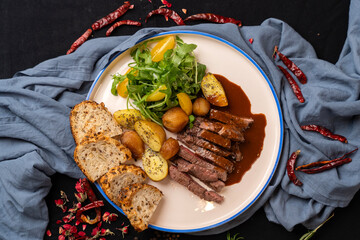 Steak served with fries, bread and fresh vegetable salad