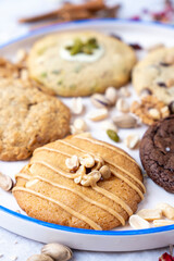 Hazelnut, chocolate and pistachio cookies served on a ceramic tray