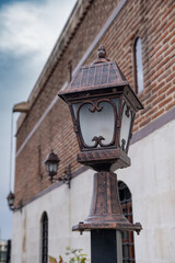 Fototapeta na wymiar antique style lantern. Vintage lighting lamp in the garden of the historical building.