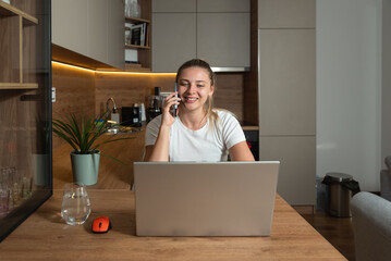 Simple living. Young freelance business woman working at home on laptop as product strategy expert. Female expatriate remote work on internet on computer online for foreign company as web developer.
