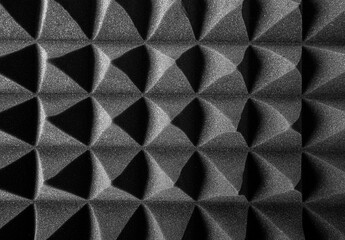 Black pyramids as an abstract background. Acoustic foam.