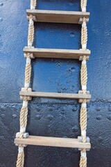 Closeup of rope ladder on side of black ship for embarking and disembarking. © Raimo Bergroth