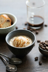 Italian affogato in a ceramic cup on a dark background. Ice cream and coffee, selective focus