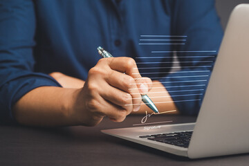 Signature Electronic. Businessman uses a pen to sign electronic documents on a virtual screen while...