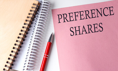 PREFERENCE SHARE word on the pink paper with office tools on white background