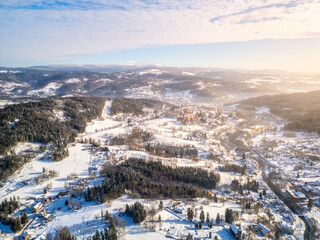 Fototapeta premium Tanvald in wintertime. Small town in Jizera Mountains, Czechia. Aerial photography from above.
