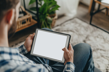 cropped view of man holding digital tablet with blank screen at home
