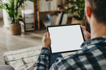 cropped view of man holding digital tablet with blank screen at home