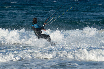 Obraz premium Kite surfing.Windsurf.Kite boarding. To fly a kite. Surfers of all ages train in the Mediterranean. Flying a kite on the beaches of Cyprus.
