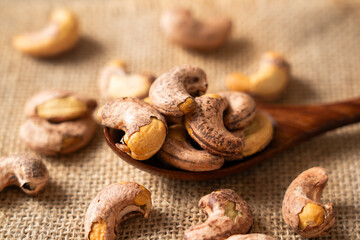 Obraz na płótnie Canvas roasted salted cashew nuts on table.