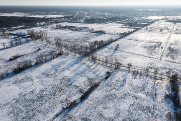 Fields, meadows and pasture covered with snow in winter in Poland. Winter rural landscape.