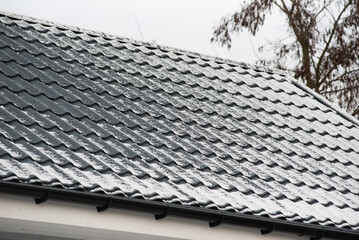 The roof of the house covered with snow, winter season.