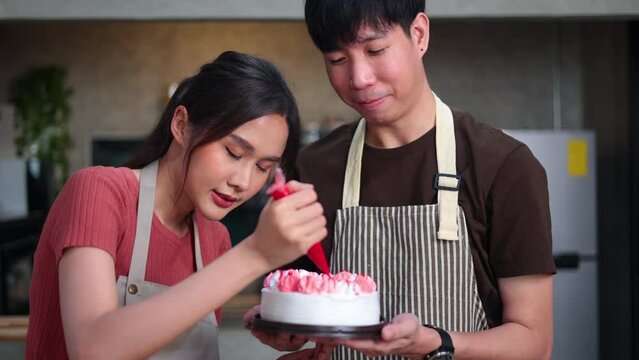 Homemade, happy relaxing and wellness at home. Young asian man and woman preparing birthday cake for friends