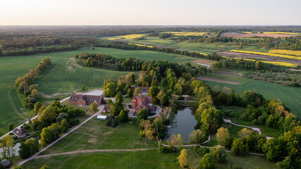 Jaunmoku medieval brick castle complex with pond and park near Tukums, Latvia, drone view