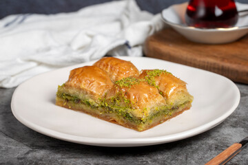 Pistachio baklava. Baklava with pistachios on a dark background. Turkish cuisine flavors. Close up