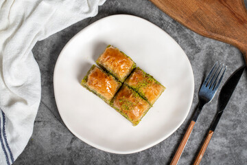 Pistachio baklava. Baklava with pistachios on a dark background. Turkish cuisine flavors. Top view
