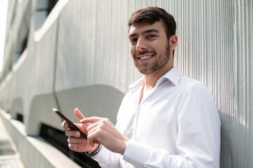 Young elegant man with a phone in hands