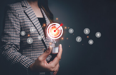 Businesswoman holding a light bulb with target icon. Inspiration for online marketing on network...