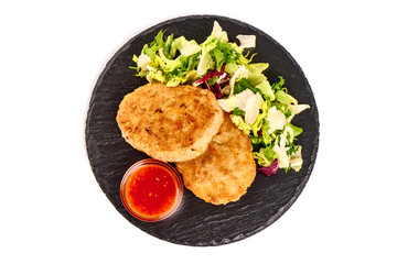 Fried pork schnitzels in breadcrumbs, isolated on white background.