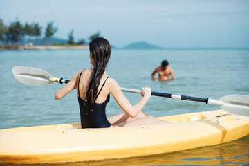 Kayaking Couple: The Beautiful Synchronization of Adventure and Togetherness on a Serene Tropical Lake