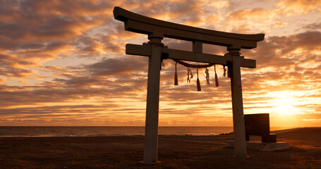 Torii gate, sunset sky in Japan with clouds, zen and spiritual history on travel adventure. Shinto architecture, Asian culture and calm nature on Japanese landscape with sacred monument at shrine.