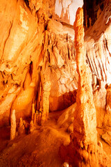 Underground interior of the Coin Cave with lake, stalactites, stalagmites and other rock formations.Vila de Ourém