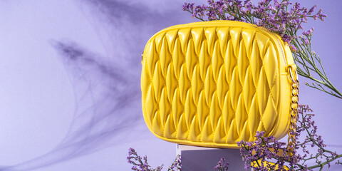 Yellow fashion lady handbag with purple flowers on monochrome background - 717872171