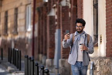 Brunette young hindu man making pictures in the street