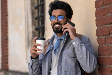 Smiling dark-haired man talking on the phone