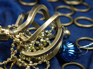 Accessories for brass twisted curtain rod  lie on a blue satin curtain