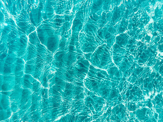 Blue water surface viewed from above in outdoor sea, sun reflection, dimply. Surface Abstract...