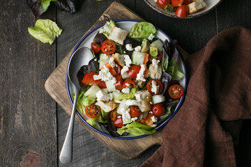 Traditional italian tomato salad panzanella with mozzarella, capers, red onion and croutons. Summer...
