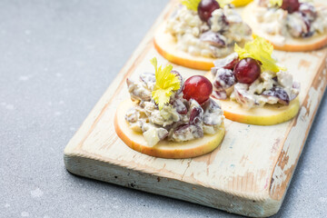 Waldorf salad with copy space. American fruit and nut salad with apples, celery, grapes, chicken meat, dressed mayonnaise.