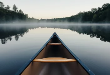 Foto op Canvas Bow of a canoe in the morning on a misty lake © Angs