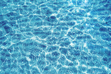 Blue water surface viewed from above in outdoor sea, sun reflection, dimply. Surface Abstract...