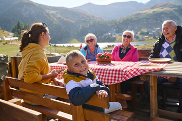 A family on a mountain vacation indulges in the pleasures of a healthy life, savoring traditional...