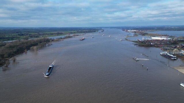 Aerial view of cargo vessels and ships sailing through wide part of the Rhine near Lobith, during extremely high water levels in the Netherlands
