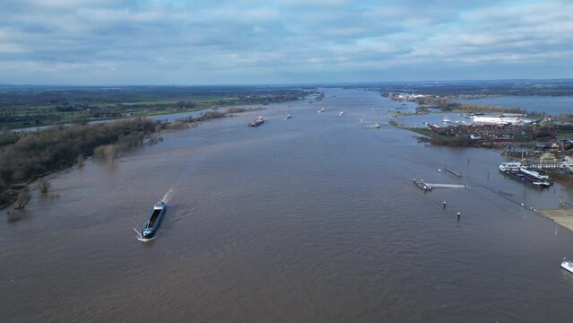 Aerial view of cargo vessels and ships sailing through wide part of the Rhine near Lobith, during extremely high water levels in the Netherlands
