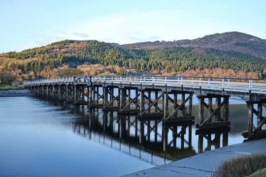 Old timber trestle bridge over the River Mawddach in North Wales, UK