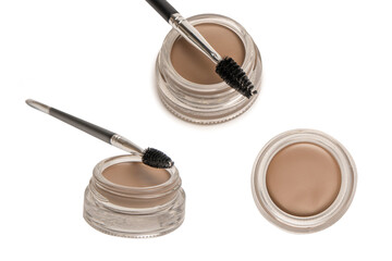 A brow pomade in blonde shade with brush isolated on a white background.