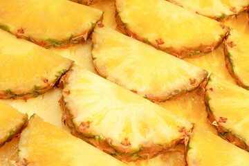 Pineapple juicy yellow slices as a background.