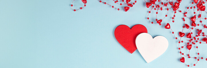 banner of Valentine's Day background. Two hearts with red confetti, beads with hearts on pastel...