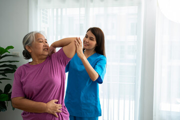 A young Asian women Physiotherapist Nursing is assisting an elderly woman exercise stretching...
