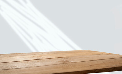 empty table with window shadow on light wall background for product mockup display. kitchen interior theme
