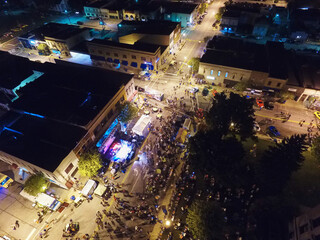 Aerial Nighttime Urban Event with Stage Lighting and Crowd in Indiana