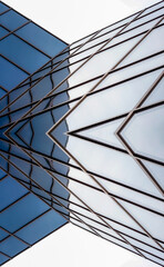 distorted reflections in the mirrored windows of a modern building