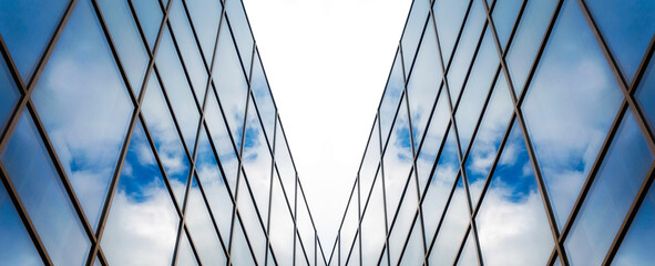 reflection of blue sky with clouds in an office building window - obrazy, fototapety, plakaty