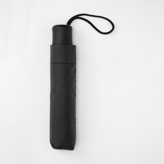 Folded cover umbrella isolated on white background with clipping path. Umbrella with handle for mock up. Copy space, design template for mock-up, branding, advertise etc. Studio Photography shoot