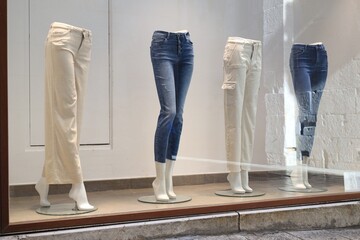 Shop display with mannequins in stylish pants - obrazy, fototapety, plakaty