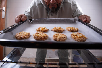 Man with cookies ready to put in the oven.